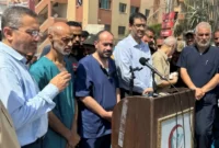 Dr Mohammad Abu Salmiya, ketiga dari kanan, berbicara kepada media pada hari Senin [Mohammed Salem/Reuters]